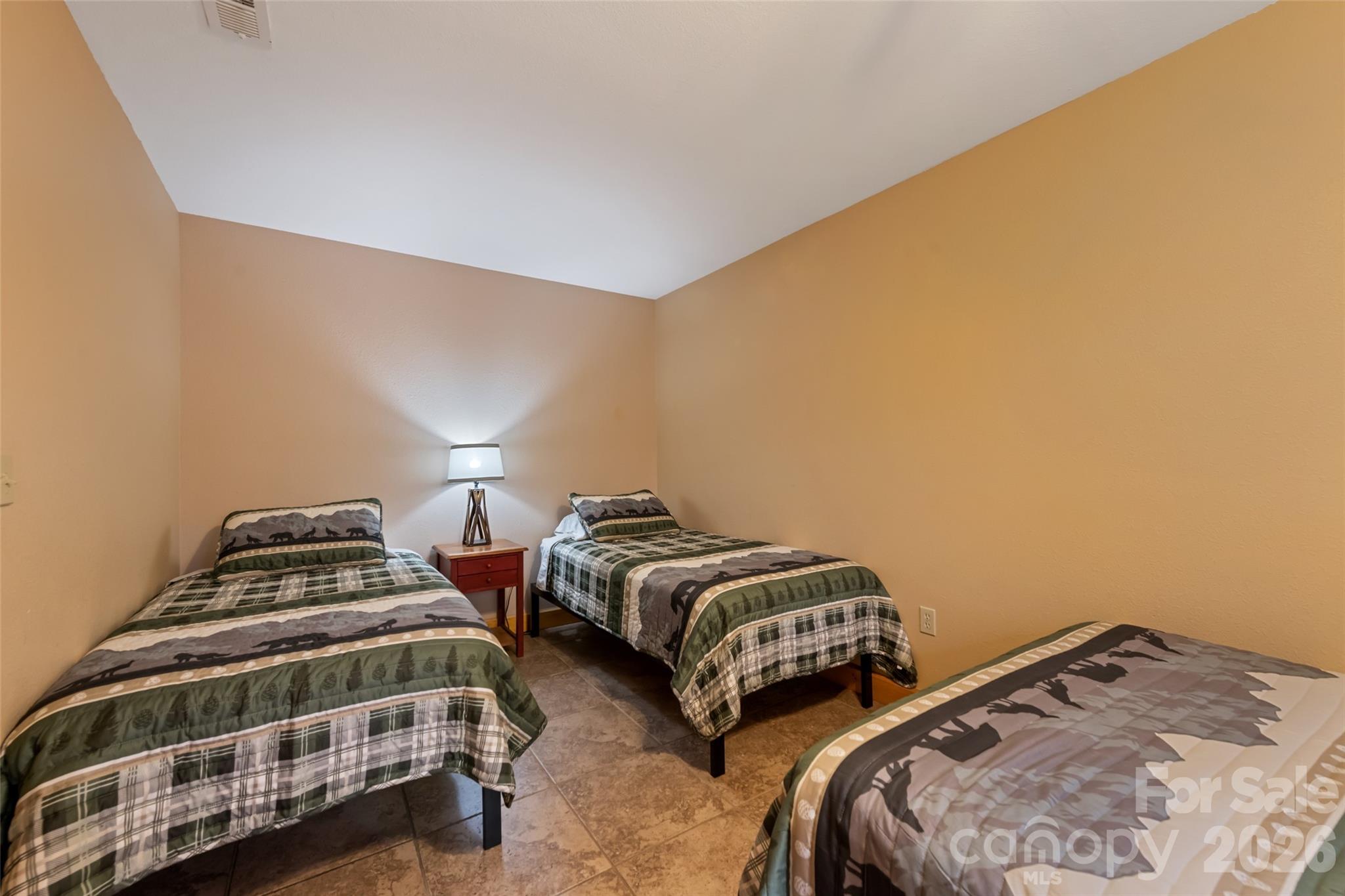 235 Soaring Eagle Road Bryson City, NC 28713 - Photo 35 of 42 a bedroom with two beds and a chair