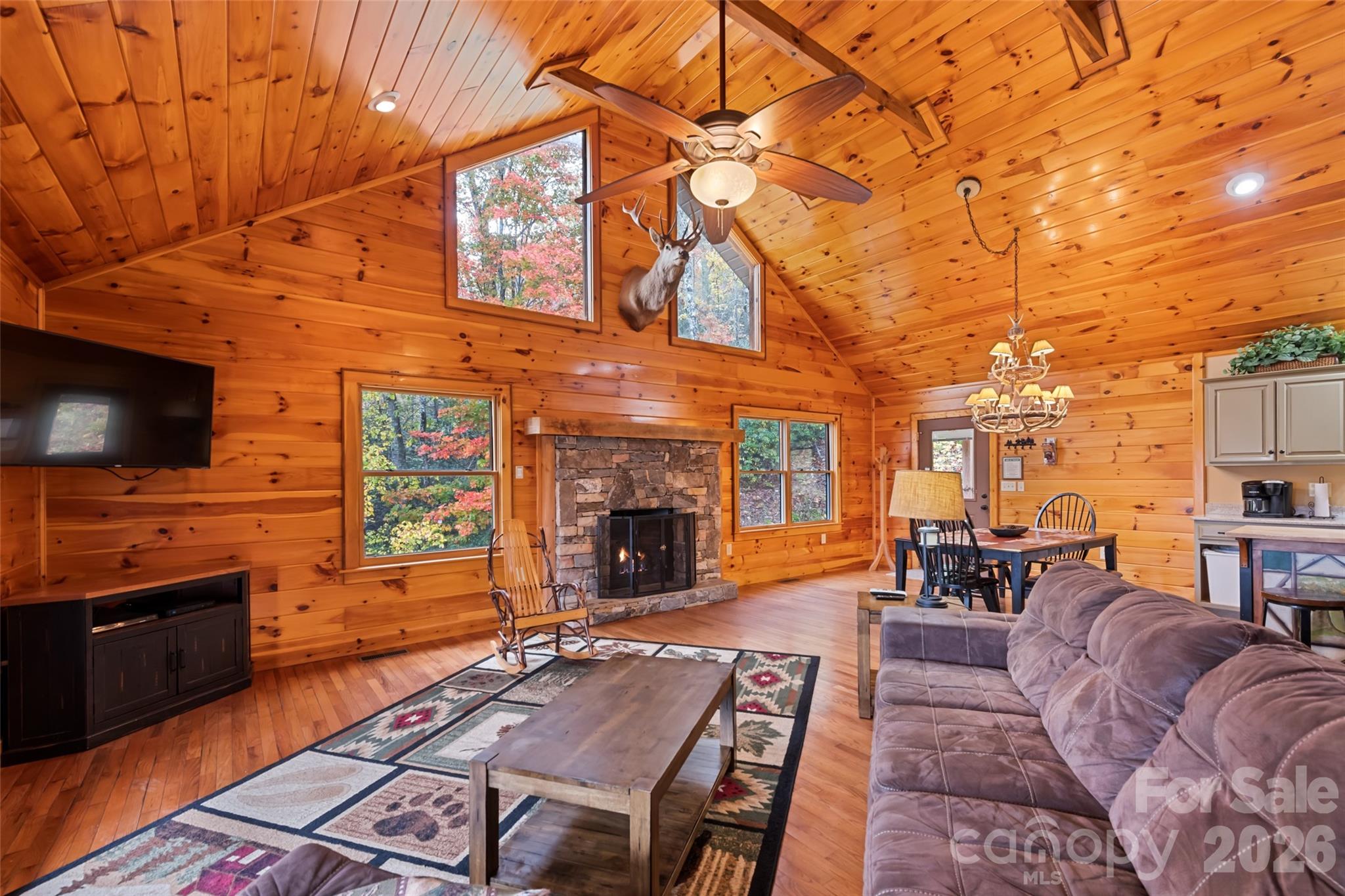 235 Soaring Eagle Road Bryson City, NC 28713 - Photo 7 of 42 a living room with furniture a flat screen tv and kitchen view