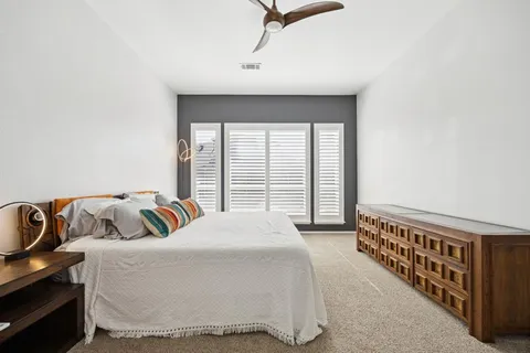 a living room with furniture ceiling fan and a window