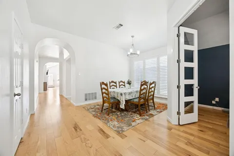 a dining room with furniture and wooden floor