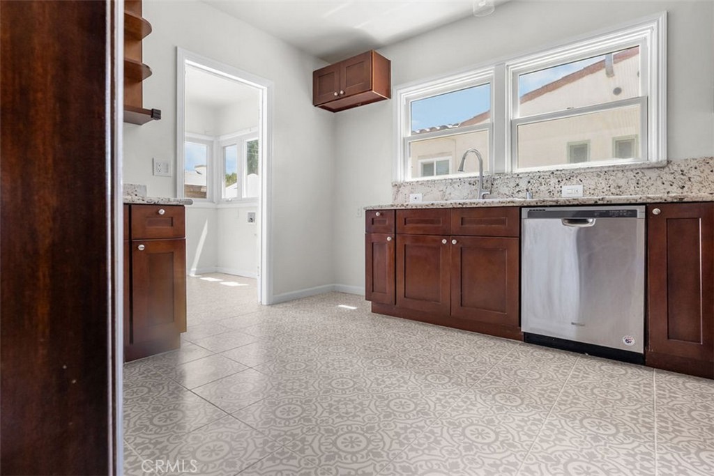 3569 Bandini Avenue Riverside, CA 92506 - Photo 14 of 51 a bathroom with a granite countertop sink and a mirror