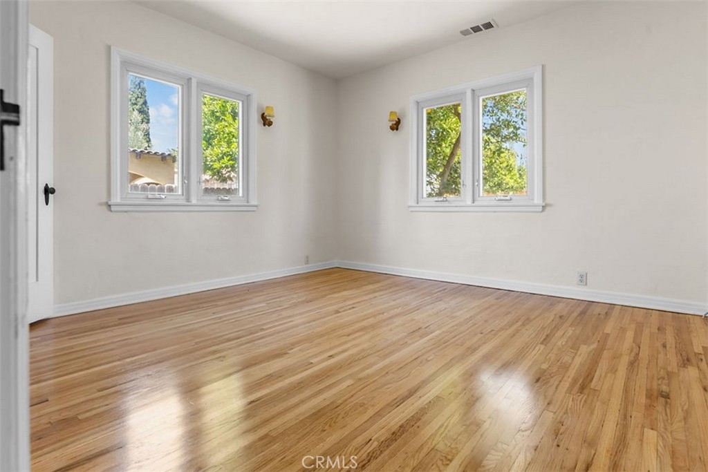 3569 Bandini Avenue Riverside, CA 92506 - Photo 15 of 51 a view of an empty room with window and wooden floor