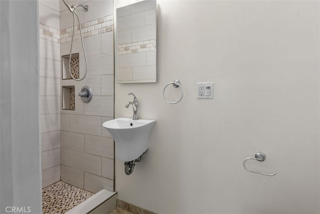 3569 Bandini Avenue Riverside, CA 92506 - Photo 17 of 51 a bathroom with a sink mirror and shower