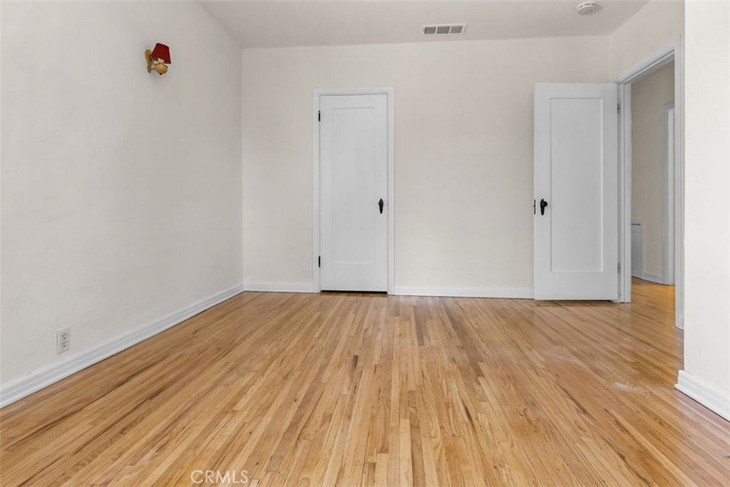 3569 Bandini Avenue Riverside, CA 92506 - Photo 21 of 51 a view of a room with wooden floor and white doors