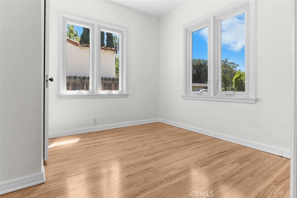3569 Bandini Avenue Riverside, CA 92506 - Photo 23 of 51 a view of an empty room with wooden floor and a window