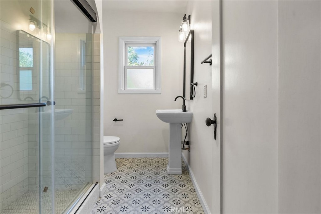 3569 Bandini Avenue Riverside, CA 92506 - Photo 25 of 51 a bathroom with a sink a toilet and shower