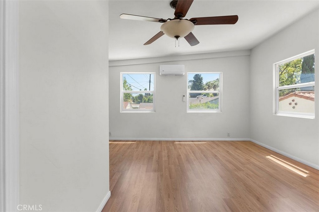 3569 Bandini Avenue Riverside, CA 92506 - Photo 29 of 51 an empty room with wooden floor ceiling fan and windows