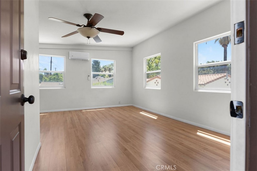 3569 Bandini Avenue Riverside, CA 92506 - Photo 30 of 51 a view of an empty room with wooden floor and a window