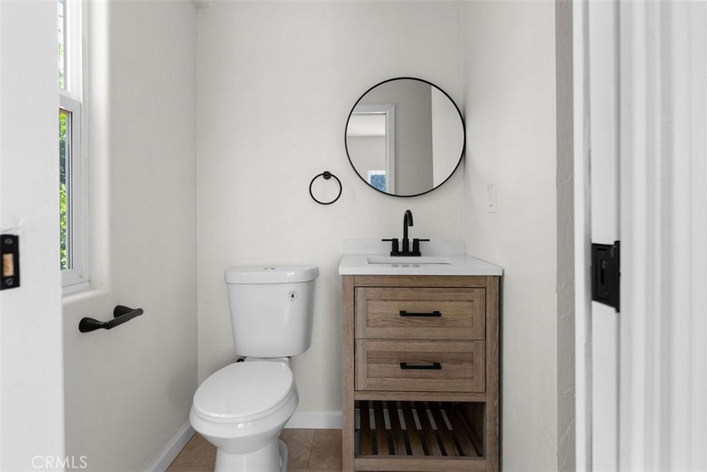 3569 Bandini Avenue Riverside, CA 92506 - Photo 34 of 51 a bathroom with a toilet a sink and a mirror