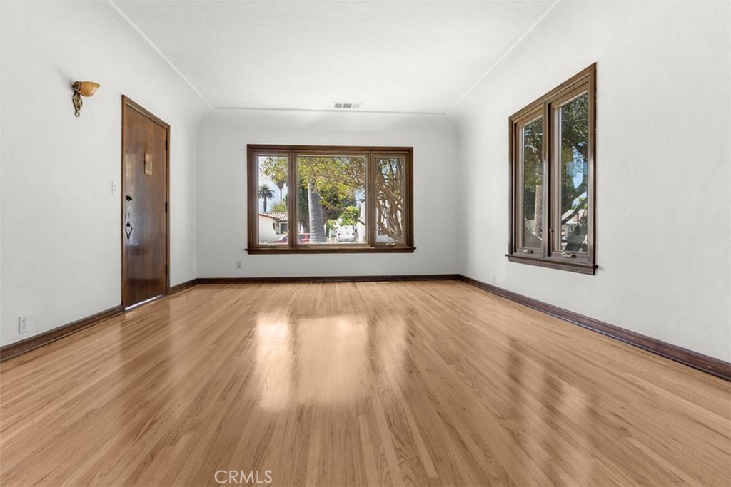 3569 Bandini Avenue Riverside, CA 92506 - Photo 8 of 51 an empty room with wooden floor and windows