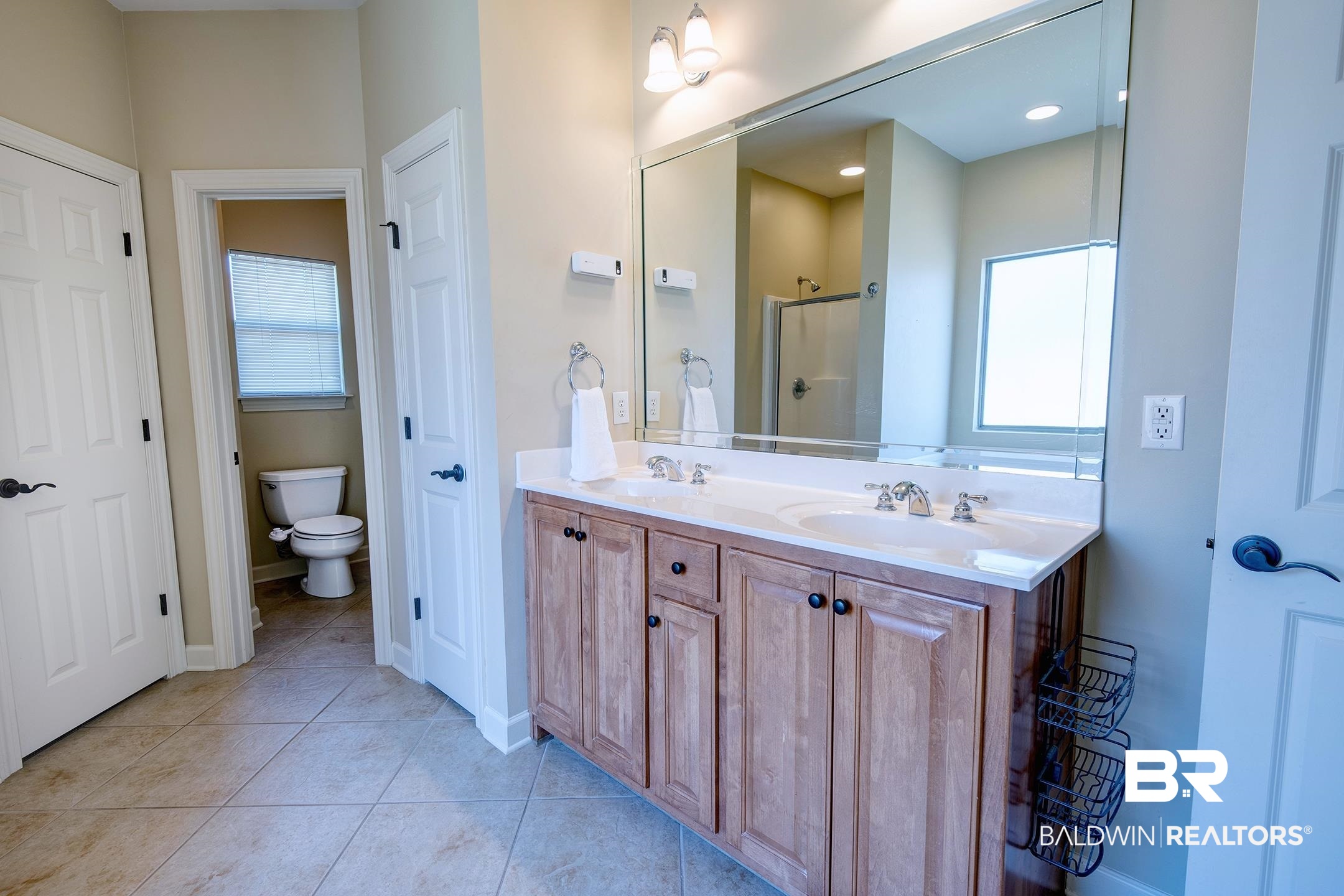 9421 Collier Loop Daphne, AL 36526 - Photo 23 of 31 Full bath with double vanity, a shower stall, and light tile patterned flooring