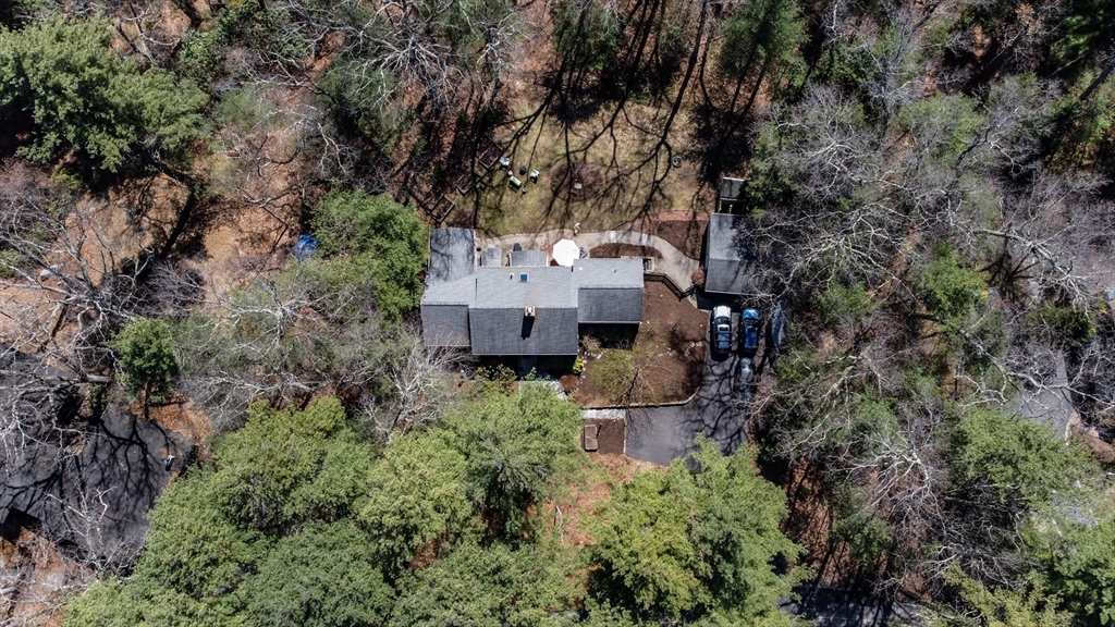 an aerial view of a house with a yard