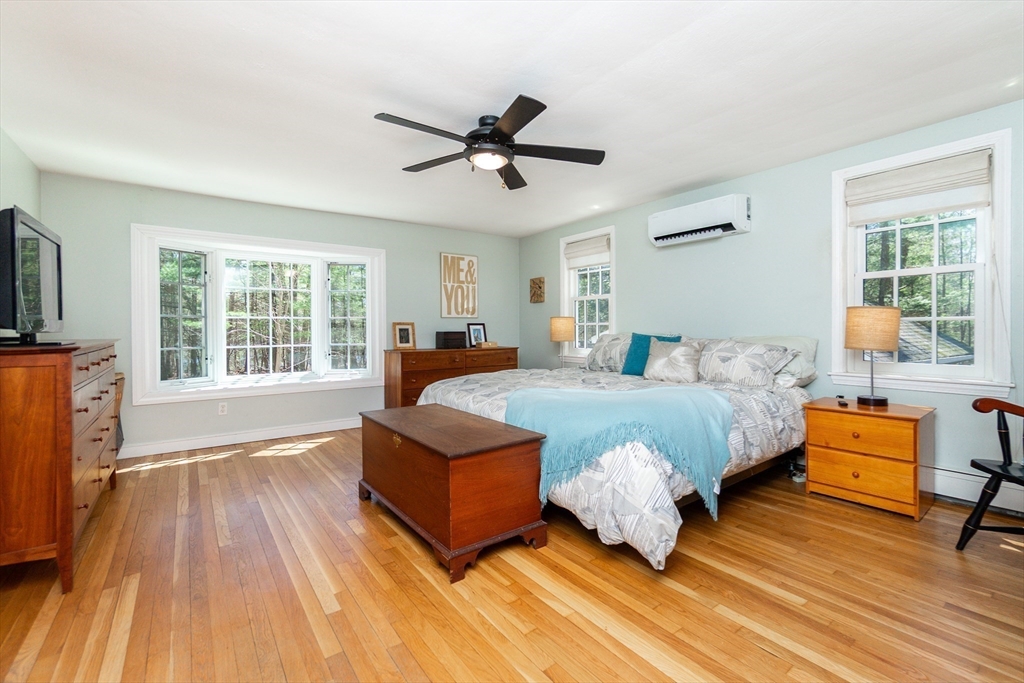 133 Glezen Lane Wayland, MA 01778 - Photo 16 of 30 a bedroom with a bed and wooden floor