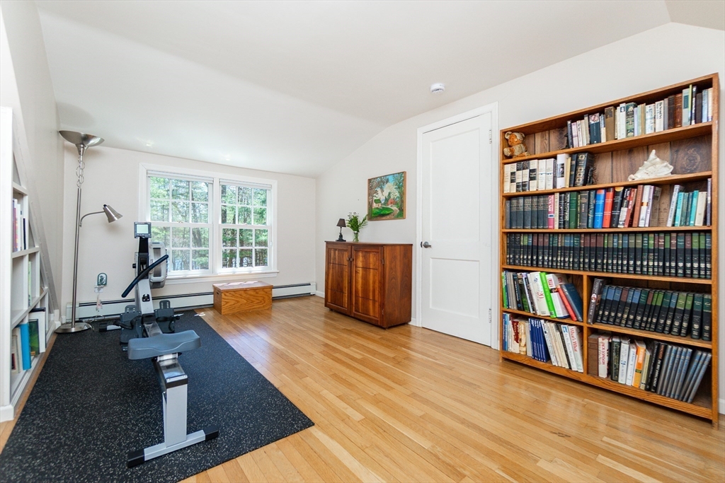 133 Glezen Lane Wayland, MA 01778 - Photo 21 of 30 a room with lots of furniture and a book shelf