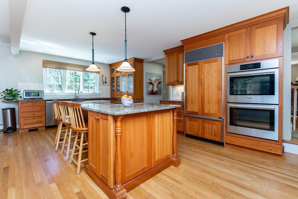 133 Glezen Lane Wayland, MA 01778 - Photo 7 of 30 a kitchen with stainless steel appliances granite countertop a stove a sink and a refrigerator