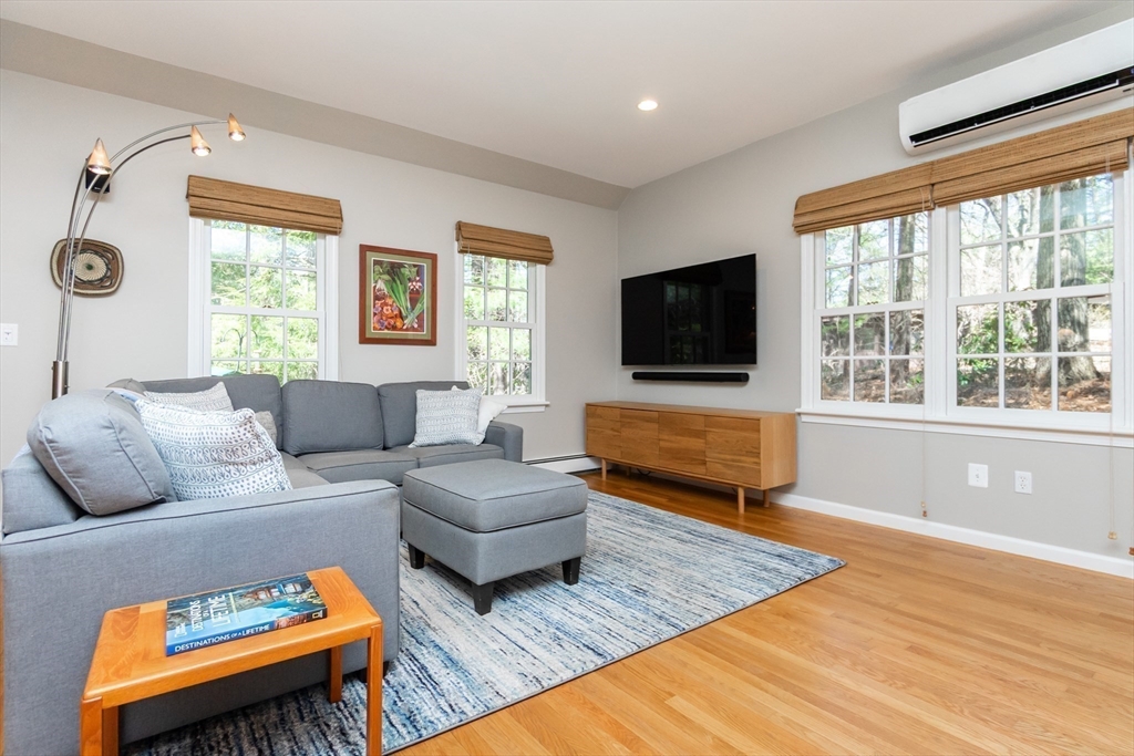 133 Glezen Lane Wayland, MA 01778 - Photo 10 of 30 a living room with furniture flat screen tv and a large window