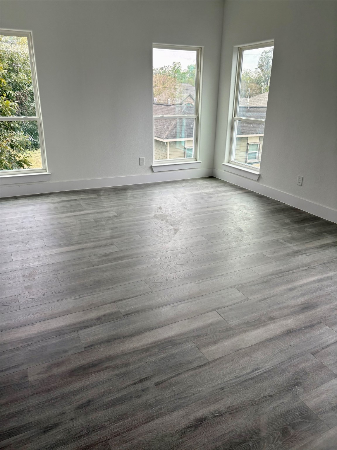 4436 Aledo Street Houston, TX 77051 - Photo 12 of 16 an empty room with wooden floor and windows