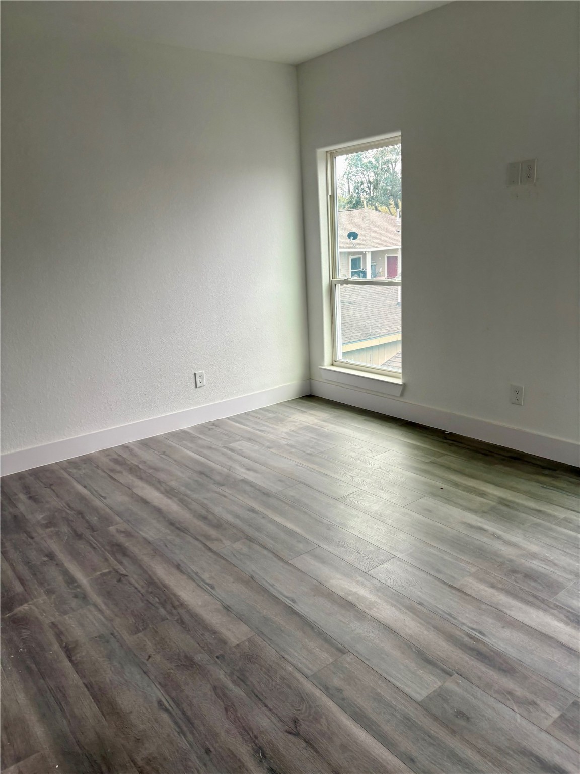 4436 Aledo Street Houston, TX 77051 - Photo 10 of 16 a view of an empty room with wooden floor and a window