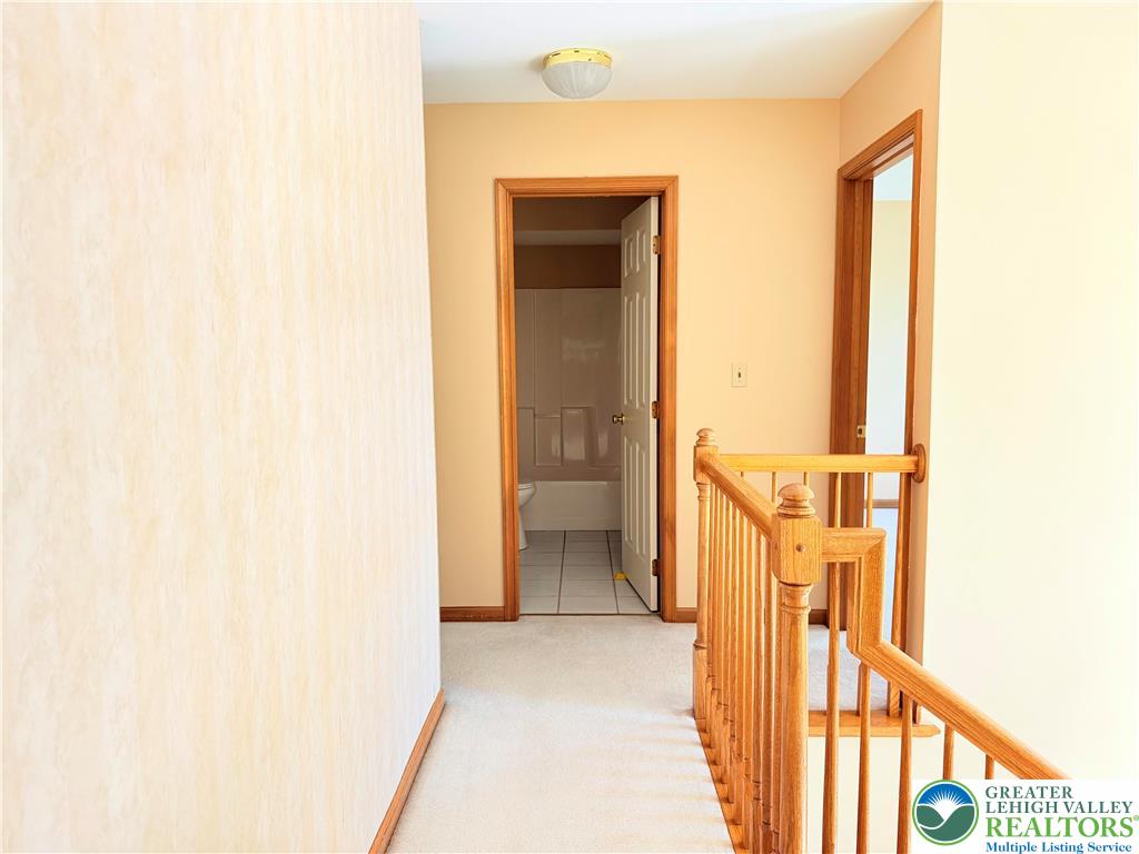 4165 Alder Road Bethlehem, PA 18020 - Photo 23 of 42 a view of a hallway with wooden floor and a bathroom