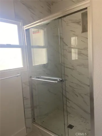 a bathroom with a glass shower door