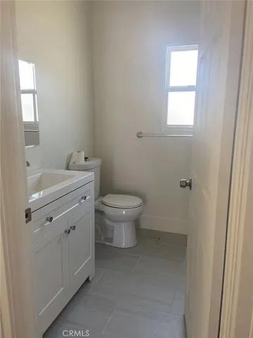a bathroom with a sink toilet and window