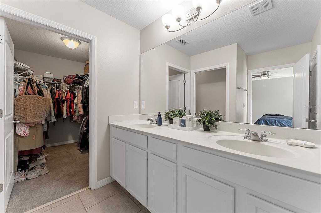 3523 Clay Brick Road St. Cloud, FL 34773 - Photo 27 of 62 a bathroom with a sink and mirror