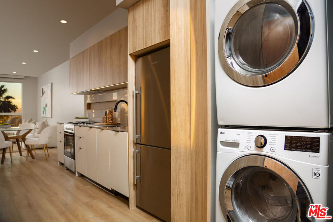 12431 Rochester Avenue, Unit 102 Los Angeles, CA 90025 - Photo 8 of 28 a view of a kitchen with washer and dryer