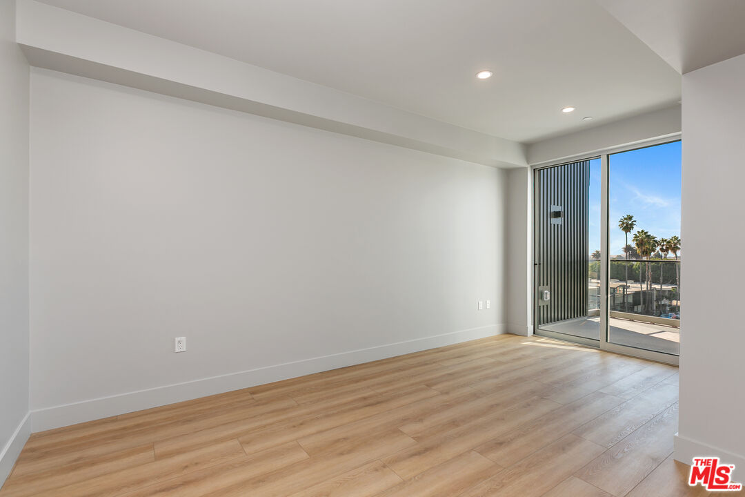 12431 Rochester Avenue, Unit 102 Los Angeles, CA 90025 - Photo 10 of 28 wooden floor in an empty room