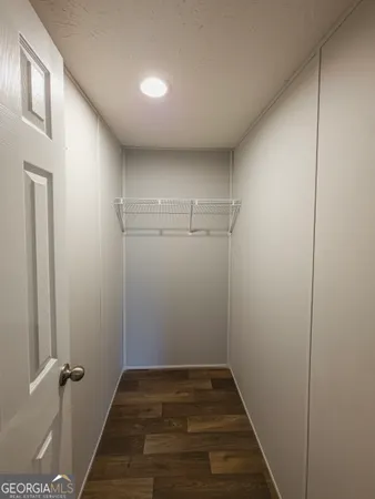 a view of a room with wooden floor