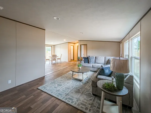 a living room with furniture and a wooden floor