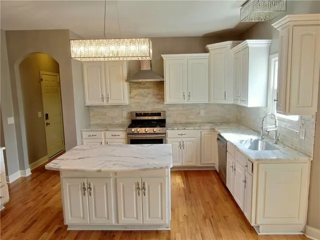 a kitchen with a sink stove and cabinets