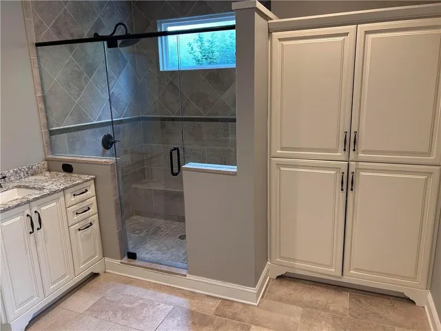 a bathroom with a shower and a sink
