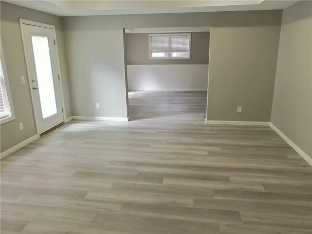 a view of wooden floor and windows in a room