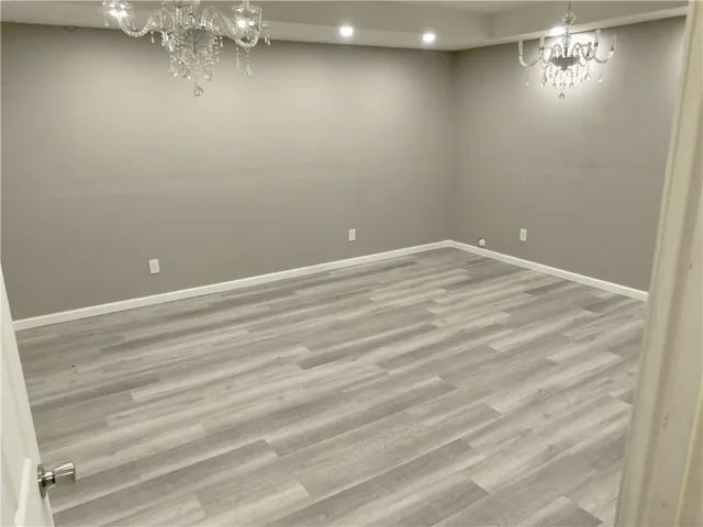 a view of an empty room with a chandelier