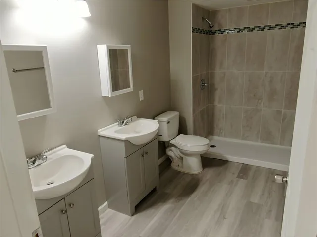 a bathroom with a sink toilet and shower