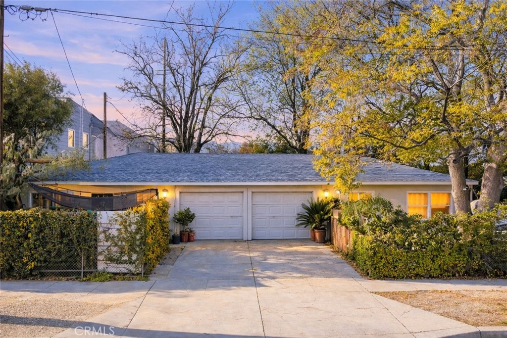 24513 Walnut Street Newhall, CA 91321 - Photo 8 of 11 a front view of a house with garden