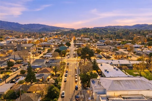 an aerial view of residential houses with a city street