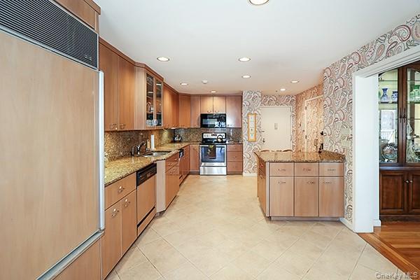 360 Shore Road, Unit 6L & 6M Long Beach, NY 11561 - Photo 16 of 33 a large kitchen with granite countertop a sink and cabinets