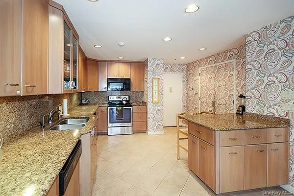 a kitchen with sink cabinets and stove top oven