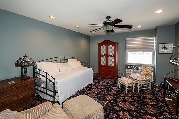 360 Shore Road, Unit 6L & 6M Long Beach, NY 11561 - Photo 22 of 33 a bedroom with a bed and a chandelier
