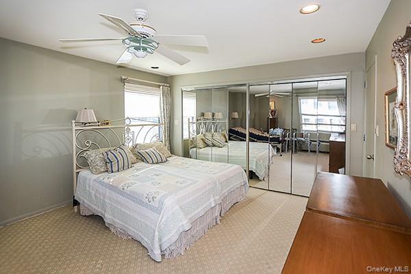 360 Shore Road, Unit 6L & 6M Long Beach, NY 11561 - Photo 24 of 33 a spacious bedroom with a large bed and chandelier