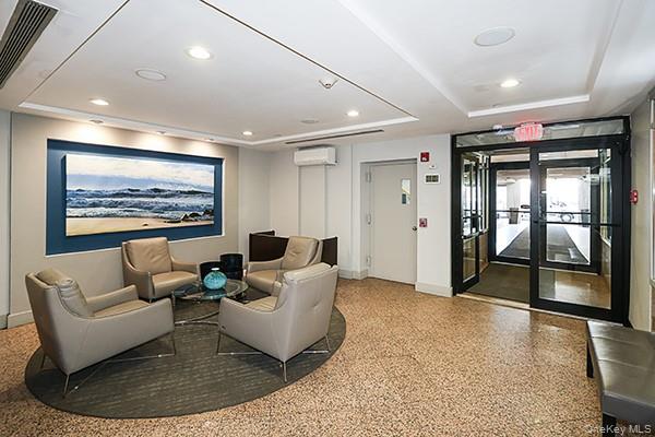360 Shore Road, Unit 6L & 6M Long Beach, NY 11561 - Photo 4 of 33 a living room with furniture and a large window
