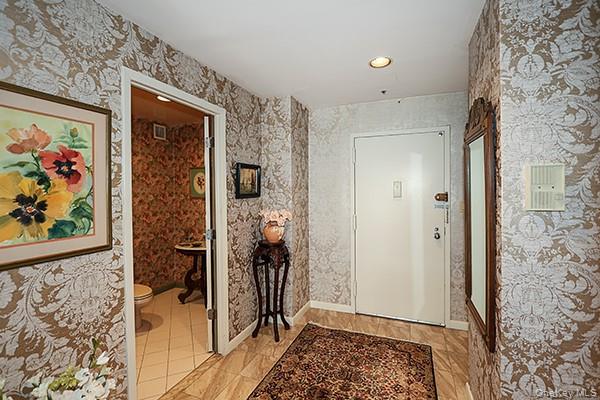 360 Shore Road, Unit 6L & 6M Long Beach, NY 11561 - Photo 5 of 33 a view of a hallway with wooden floor and a bathroom
