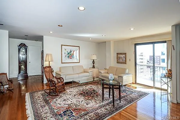 a living room with furniture a rug and a table