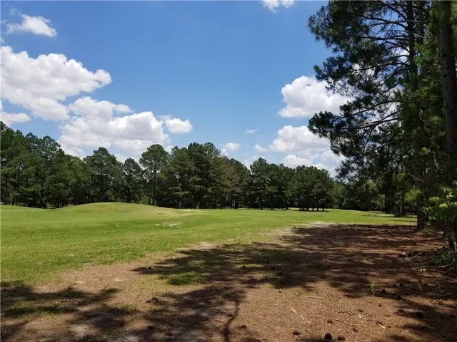 a view of a swimming pool with an outdoor space and seating area
