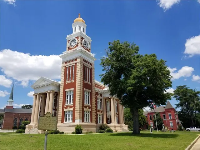 a front view of a building with a garden