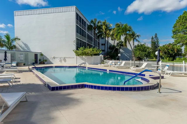 a view of swimming pool with outdoor seating and plants