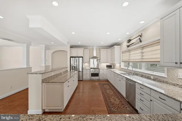 a kitchen with white cabinets and appliances