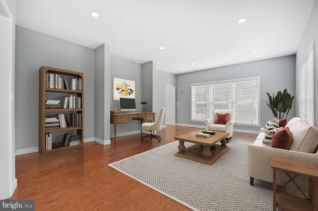 a kitchen with a refrigerator stove and white cabinets with wooden floor