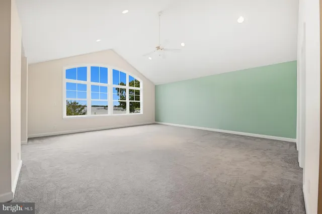 a spacious bedroom with a bed and a potted plant